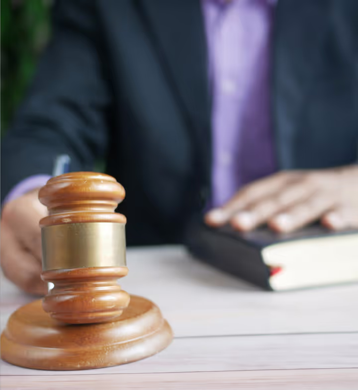 Somebody knocks the hammer of justice while holding a book